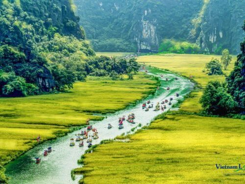 Tam Coc, where emerald rice paddies, meandering rivers.